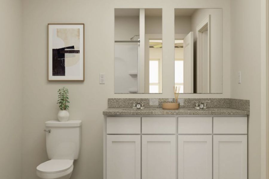 A bathroom with a marble countertop.