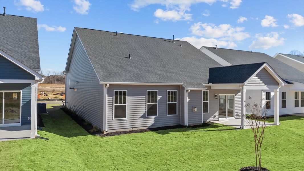 Rear covered porch creates a seamless extension of this home’s elegant design