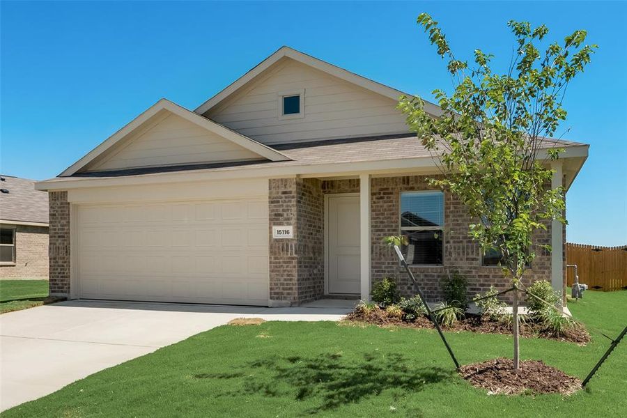 View of front of house featuring a garage and a front yard