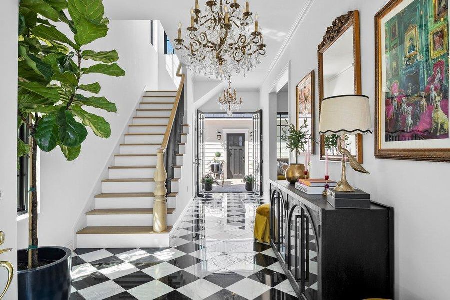 Foyer featuring ornamental molding and hanging lights
