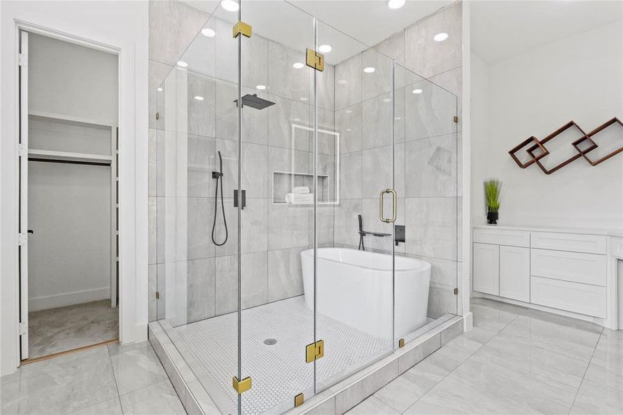 Bathroom featuring a stall shower, a freestanding tub, a spacious closet, and recessed lighting Bathroom featuring a stall shower, a freestanding tub, a spacious closet, and recessed lighting