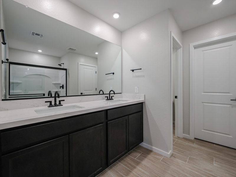A bathroom with a large mirror.