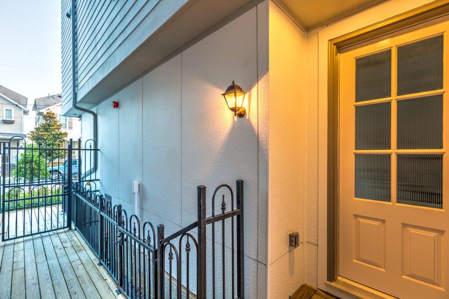 Exterior details and patio area of a home in The Brownstones at East Quarter, Dallas (Image 19). Exterior details and patio area of a home in The Brownstones at East Quarter, Dallas (Image 19).