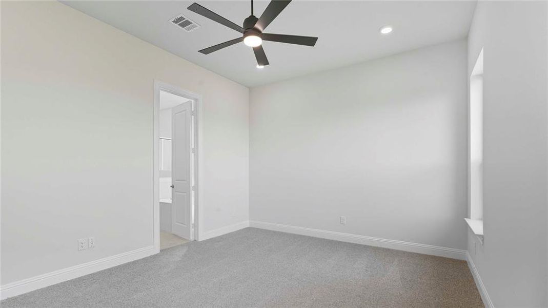 Unfurnished bedroom with light colored carpet, a ceiling fan, and recessed lighting
