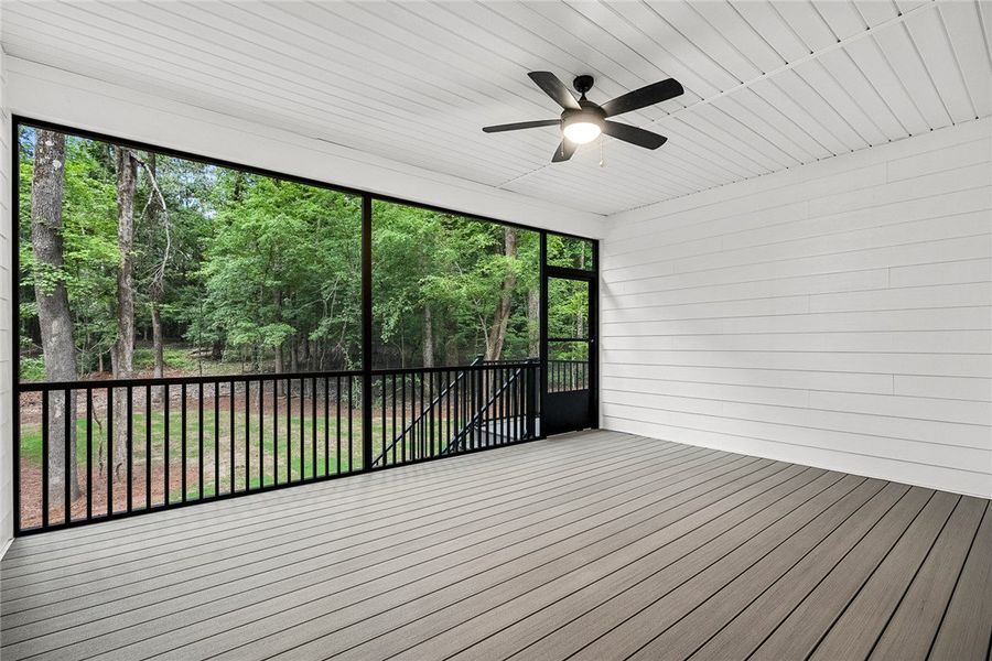 A spacious screened porch overlooks a tranquil woo A spacious screened porch overlooks a tranquil woo