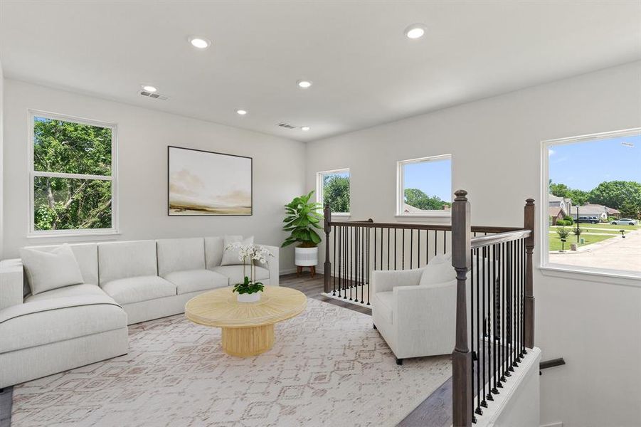 Living room featuring wood finished floors, recessed lighting, and baseboards Living room featuring wood finished floors, recessed lighting, and baseboards