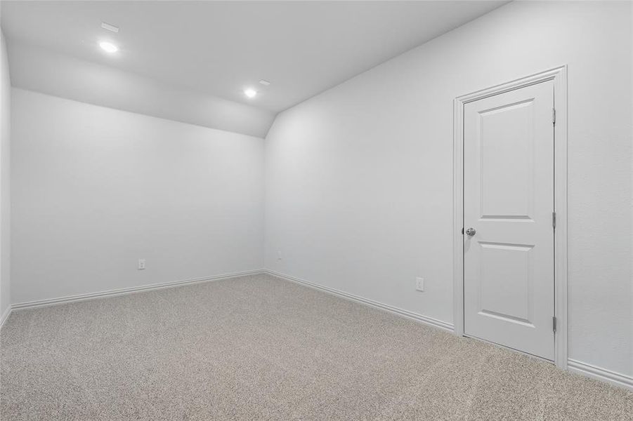 Spare room featuring carpet flooring, recessed lighting, and vaulted ceiling Spare room featuring carpet flooring, recessed lighting, and vaulted ceiling
