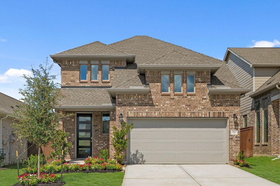 Front exterior of a new home in The Trails, New Caney, TX, highlighting curb appeal (Image 18).