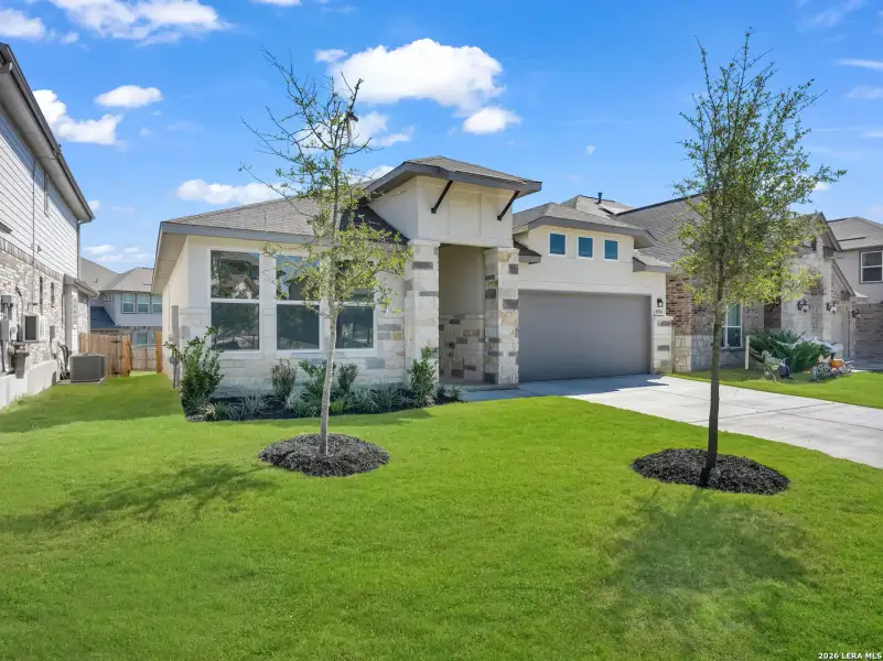 Front exterior of a new home in Comanche Ridge, San Antonio, TX, highlighting curb appeal (Image 2).