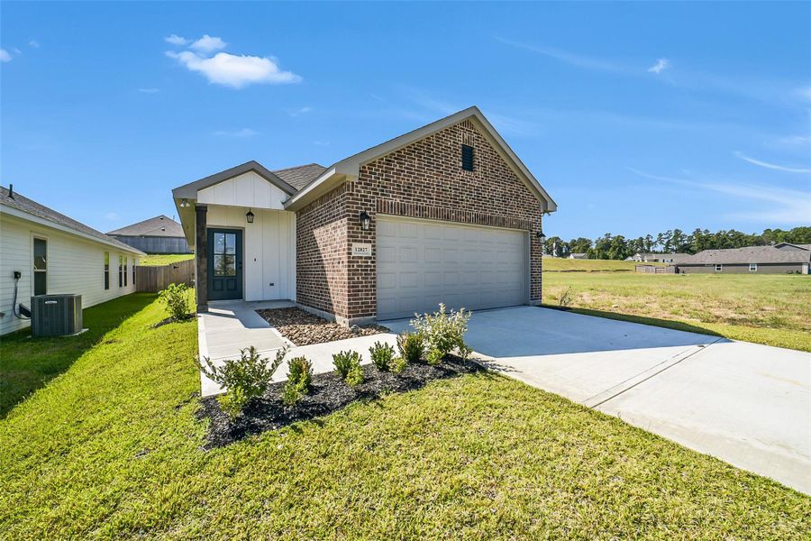Front exterior of a new home in Mostyn Springs, Magnolia, TX, highlighting curb appeal (Image 1). Front exterior of a new home in Mostyn Springs, Magnolia, TX, highlighting curb appeal (Image 1).