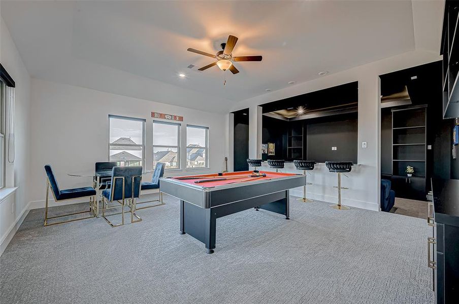 Entertainment Galore! Game Room & Media Room: The upstairs entertainment wing includes a massive game room and an adjacent media room, complete with a popcorn bar and additional storage. The game room windows offer serene views of the backyard and the picturesque neighborhood lake.