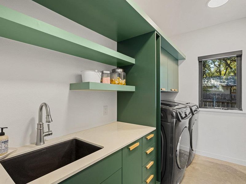 Laundry room with independent washer and dryer and cabinet space
