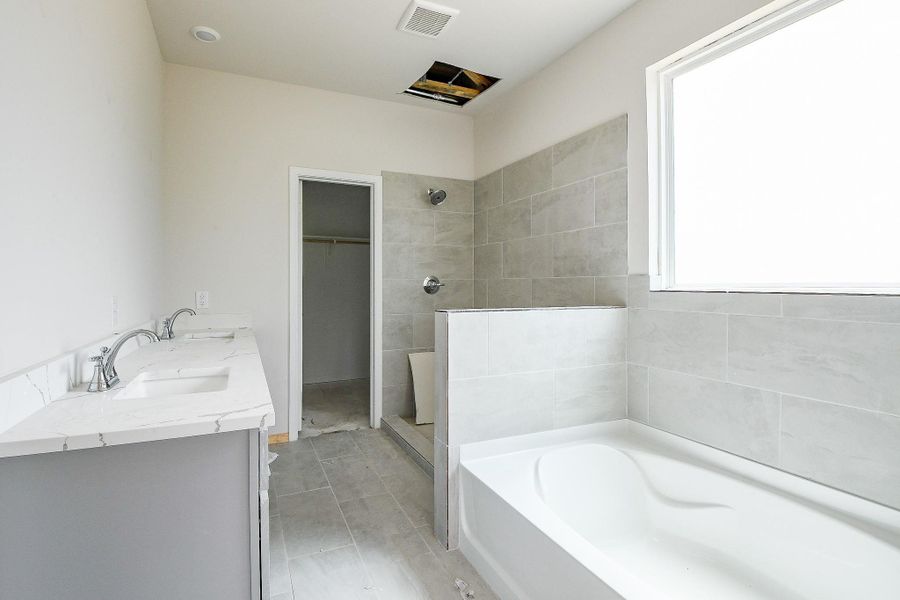 The expansive soaking tub and separate shower has a gorgeous tile wall. The expansive soaking tub and separate shower has a gorgeous tile wall.