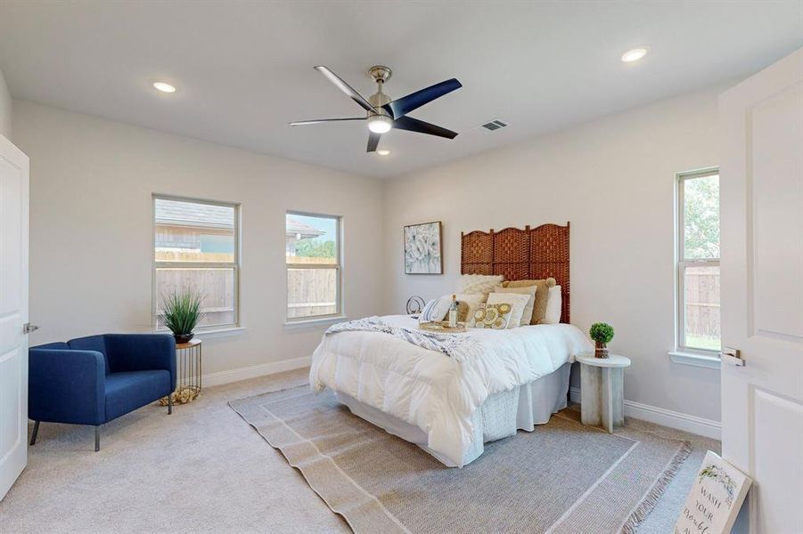 Main Carpeted bedroom with ceiling fan