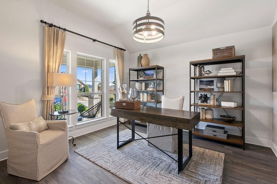 Office space featuring dark wood-style flooring and vaulted ceiling Office space featuring dark wood-style flooring and vaulted ceiling