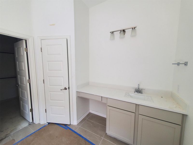 Bathroom with tile patterned floors and vanity