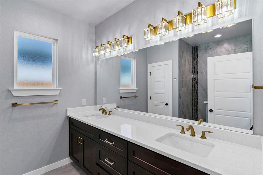 Bathroom featuring vanity and tiled shower