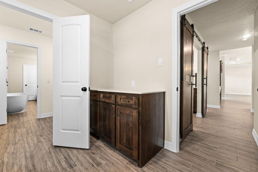 Laundry area with built-in dark brown cabinets Laundry area with built-in dark brown cabinets