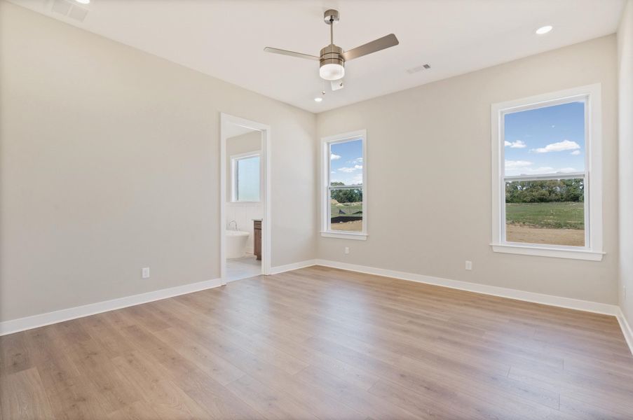 Spare room with light wood finished floors, a ceiling fan, and recessed lighting