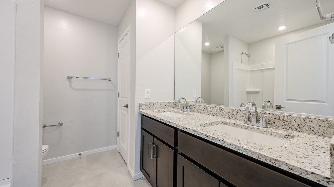 A bathroom with a marble countertop.
