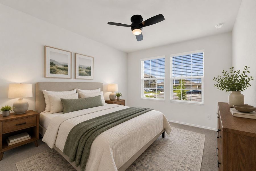 Relax in this tranquil bedroom, featuring soft neutral tones and abundant natural illumination.