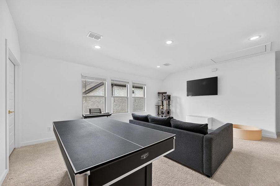 Versatile bonus room featuring light-colored carpet, recessed lighting, and multiple windows with blinds