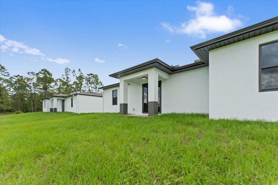 Front exterior of a new home in , Lehigh Acres, FL, highlighting curb appeal (Image 17). Front exterior of a new home in , Lehigh Acres, FL, highlighting curb appeal (Image 17).