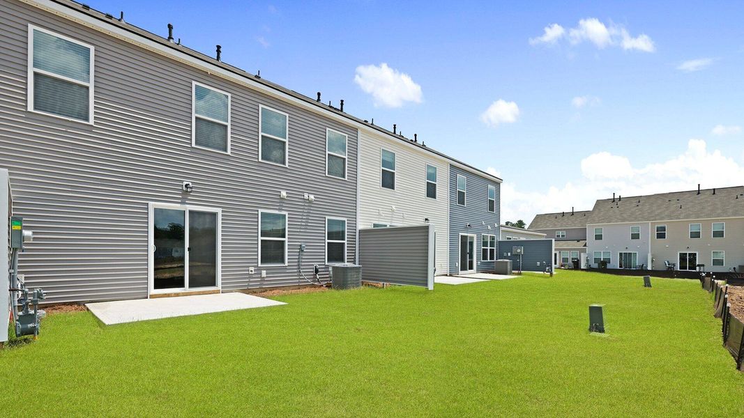 Front exterior of a new home in Pine Hills Townhomes at Cane Bay, Summerville, SC, highlighting curb appeal (Image 16). Front exterior of a new home in Pine Hills Townhomes at Cane Bay, Summerville, SC, highlighting curb appeal (Image 16).