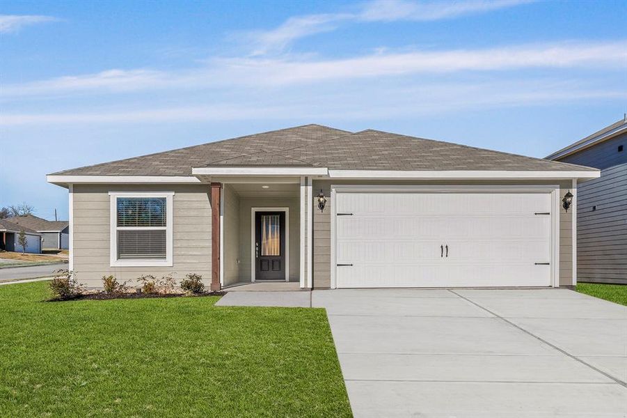 Single story home with a garage and a front yard