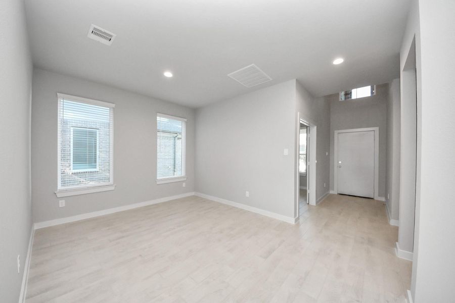 Make memories gathered around the table with your family and friends! This spacious dining room features elegant flooring, custom paint, and adjacent to family room and kitchen for open concept feel. Sample photo of completed home with similar floor plan. Actual colors and selections may vary.