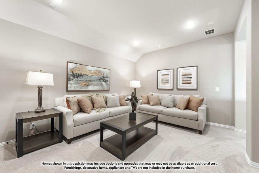 Living room with two beige sofas, dark coffee table, and vaulted ceiling on light carpet