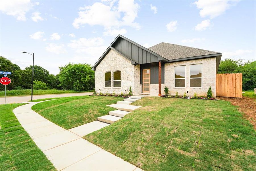 Modern home with light-toned brick and dark siding accents