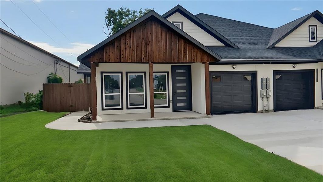 Contemporary exterior featuring a textured dark wood gable and porch columns, white siding, and a dark shingled roof