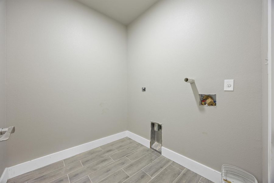 Laundry room with washer hookup, electric dryer hookup, laundry area, and wood tiled floor Laundry room with washer hookup, electric dryer hookup, laundry area, and wood tiled floor