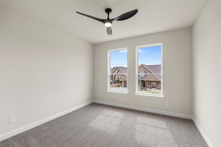 Unfurnished room with carpet floors and ceiling fan