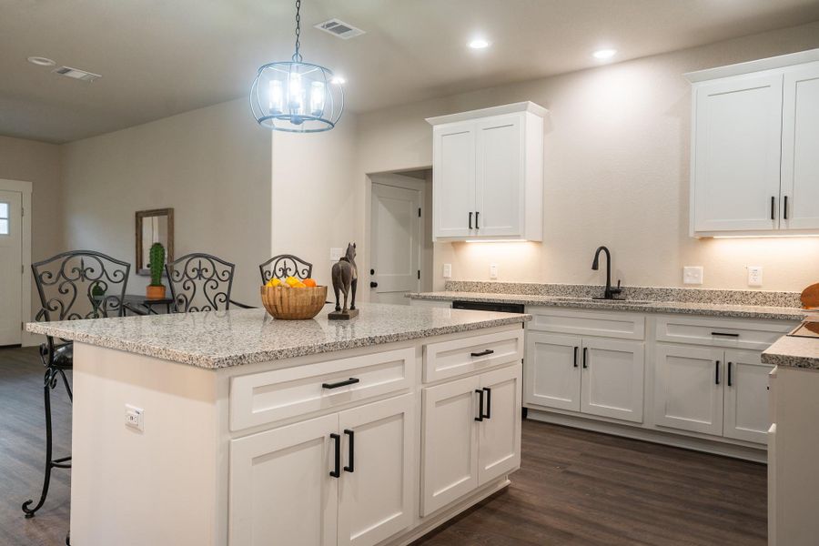 Kitchen featuring a sink, dark wood-style floors, a breakfast bar, a center island, and recessed lighting Kitchen featuring a sink, dark wood-style floors, a breakfast bar, a center island, and recessed lighting