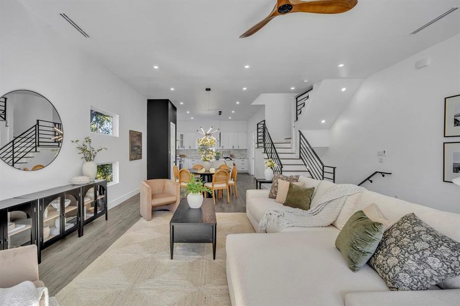 Living room featuring light hardwood / wood-style floors and ceiling fan