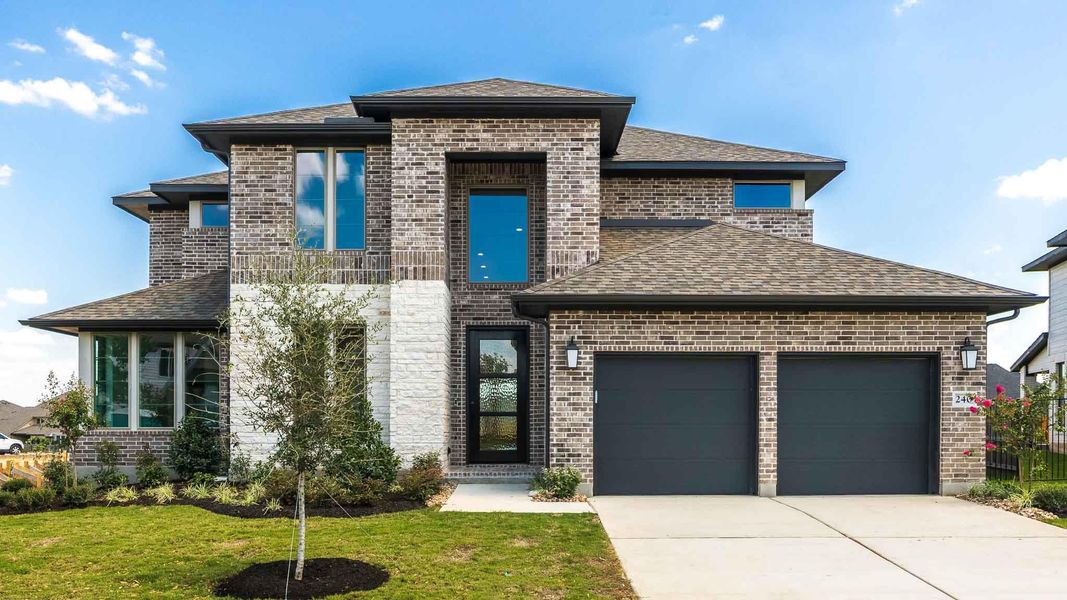 Front exterior of a new home in Santa Rita Ranch - Eldorado, Liberty Hill, TX, highlighting curb appeal (Image 2).