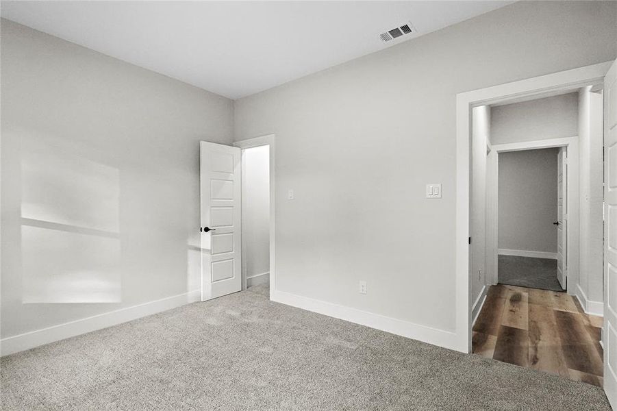 Unfurnished bedroom with carpet flooring and a closet