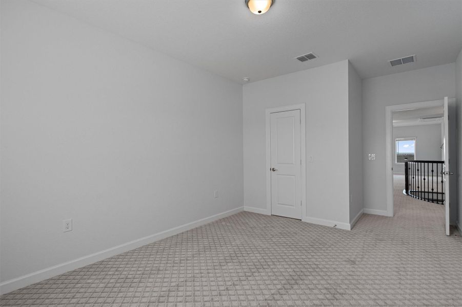 Carpeted empty room with baseboards Carpeted empty room with baseboards
