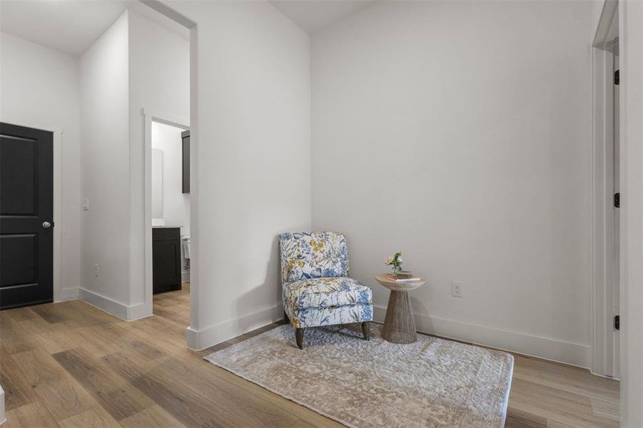 Living area featuring light wood finished floors and baseboards