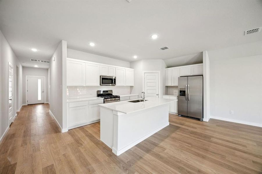 Kitchen in the Emmy II home plan by Trophy Signature Homes - REPRESENTATIVE PHOTO