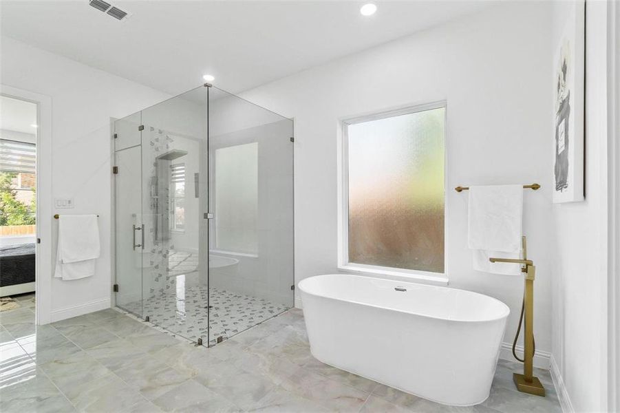 Bathroom with a soaking tub, connected bathroom, a shower stall, and recessed lighting