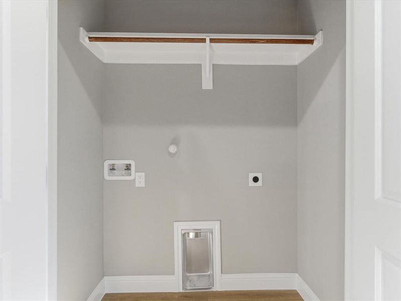 Washroom featuring gas dryer hookup, light wood finished floors, washer hookup, and hookup for an electric dryer Washroom featuring gas dryer hookup, light wood finished floors, washer hookup, and hookup for an electric dryer
