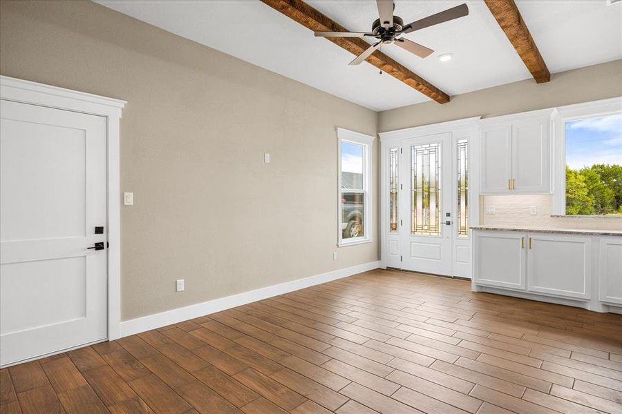 Entrance foyer featuring light wood-style floors, beamed ceiling, ceiling fan, and recessed lighting Entrance foyer featuring light wood-style floors, beamed ceiling, ceiling fan, and recessed lighting
