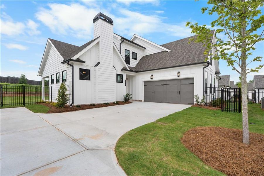 Front exterior of a new home in Promenade at Sawnee Village, Cumming, GA, highlighting curb appeal (Image 25).