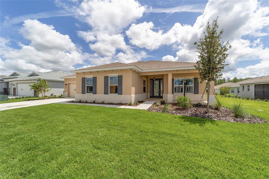 Front exterior of a new home in On Top of the World Communities, Ocala, FL, highlighting curb appeal (Image 21).
