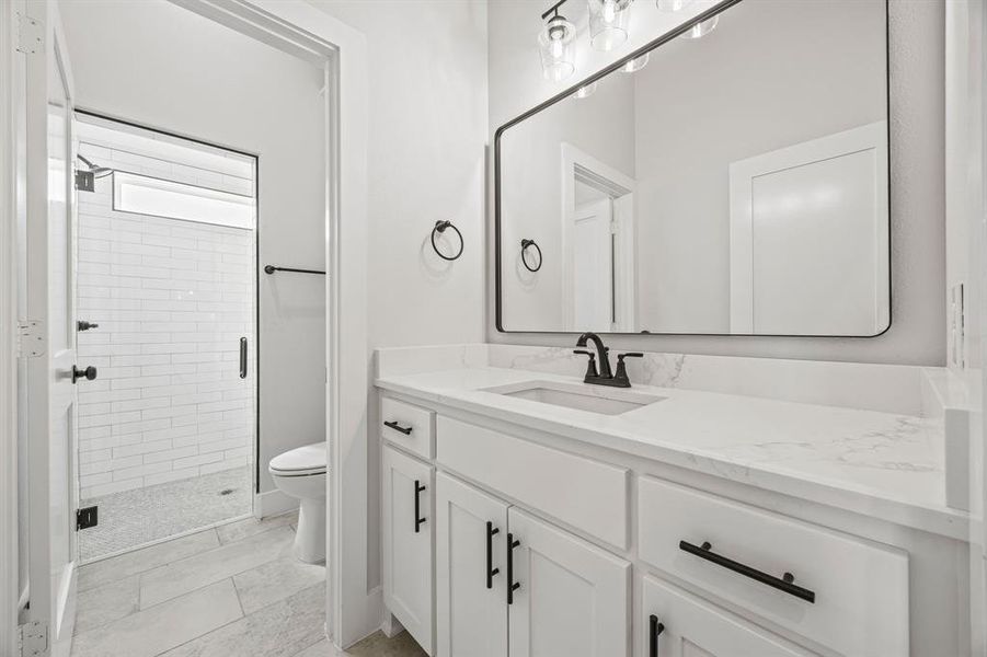 Full bathroom with vanity, a stall shower, and tile patterned floors Full bathroom with vanity, a stall shower, and tile patterned floors