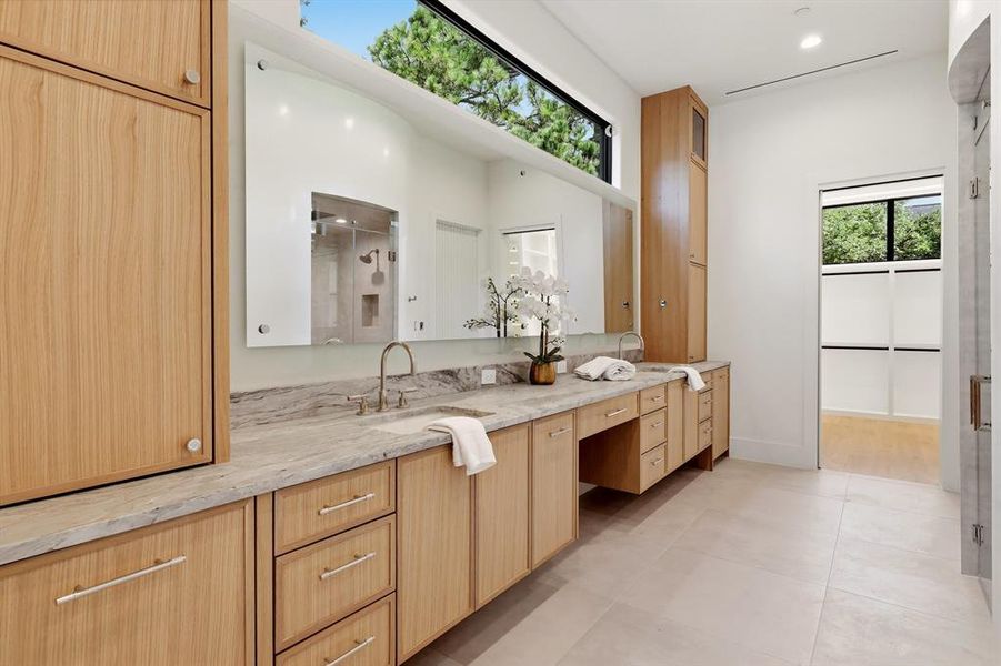 Primary bath offers a steam shower, heated tile floors, soaking tub, dual closets and dedicated washer/dryer