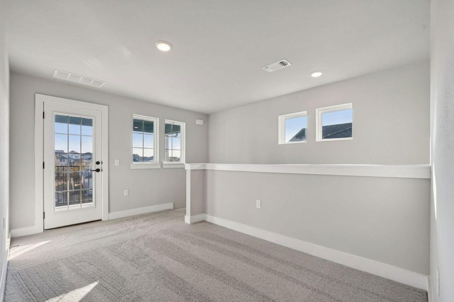 Carpeted spare room featuring plenty of natural light and recessed lighting
